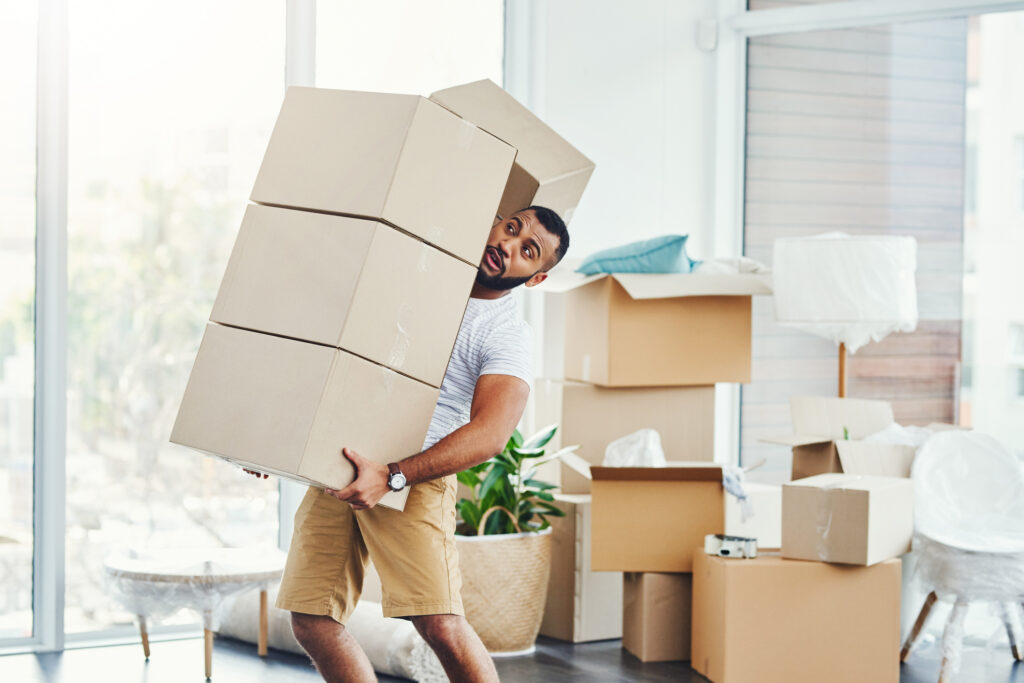 Man carrying too many boxes